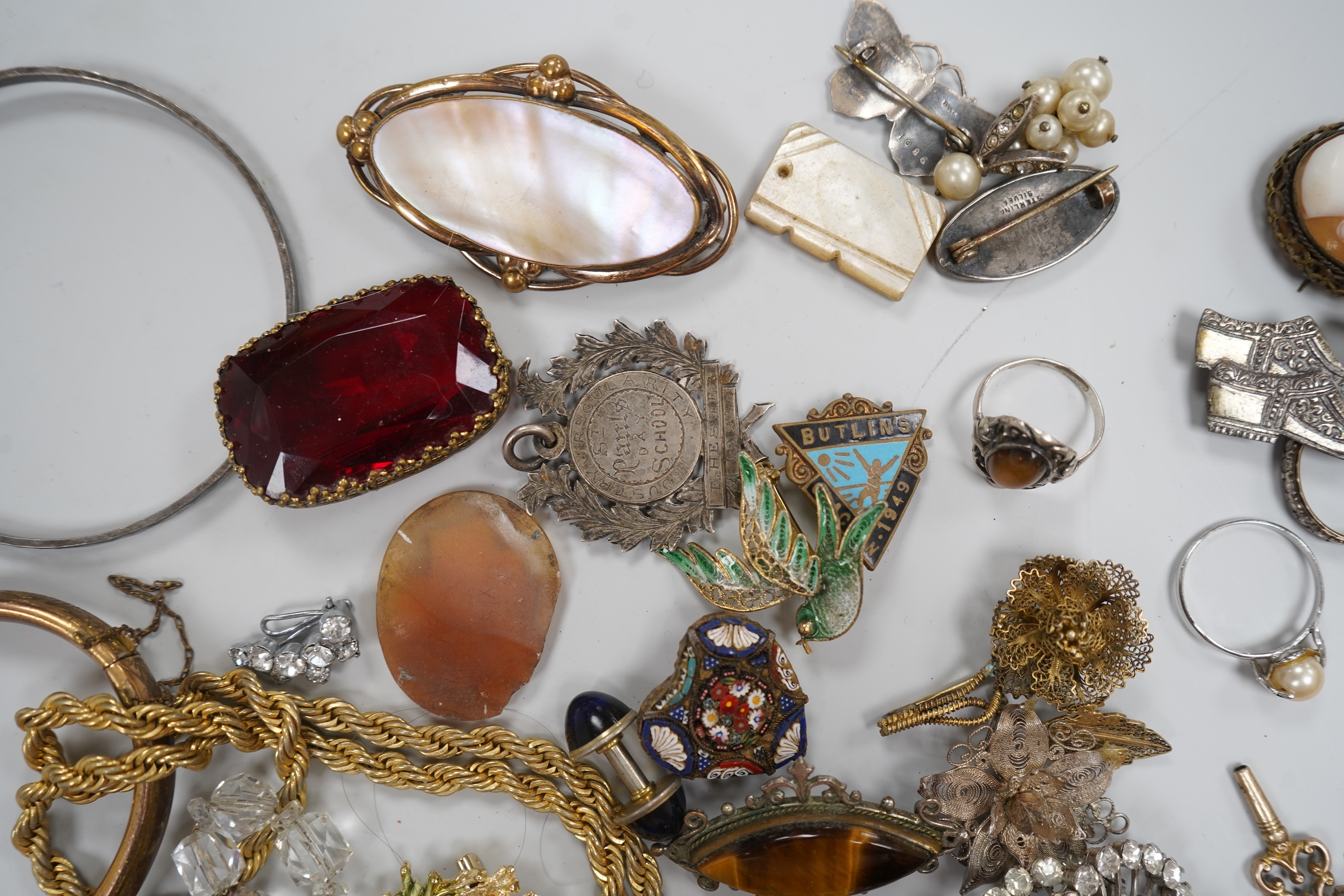 A group of costume jewellery and collector's items in a Japanese lacquer box
